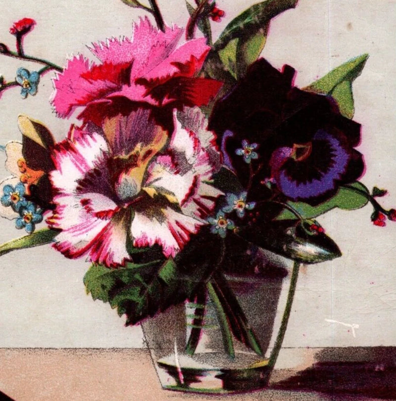 Glass vase with pink and dark purple carnation flowers bouquet and green leaves