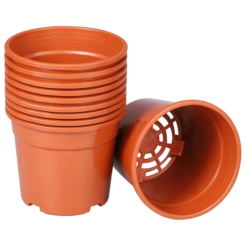 Orange plastic plant pot set with drainage hole, open bottom view