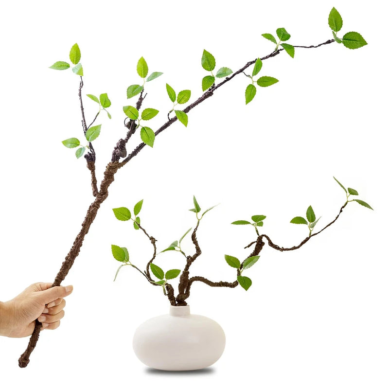 Artificial greenery stem with small green leaves, branching, shown in white vase