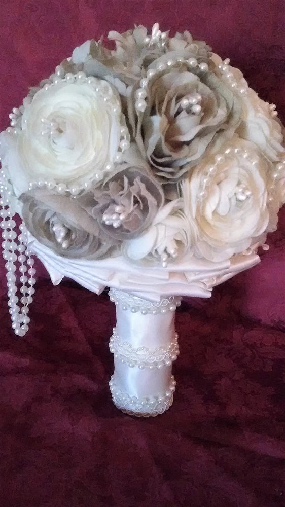 Ivory and taupe handmade wedding bouquet with fabric roses, pearls, and lace-wrapped handle