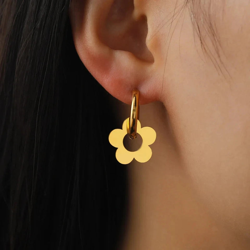 Gold-tone drop earrings with round floral charm