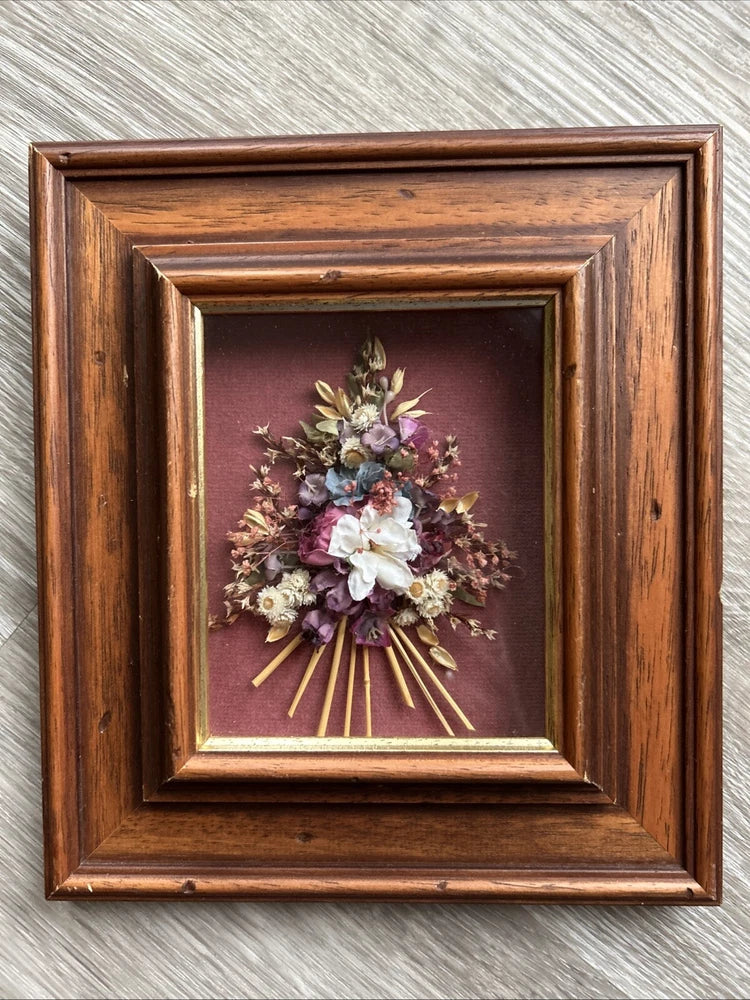 Solid wood shadow box with dried flower bouquet and purple and pink blooms