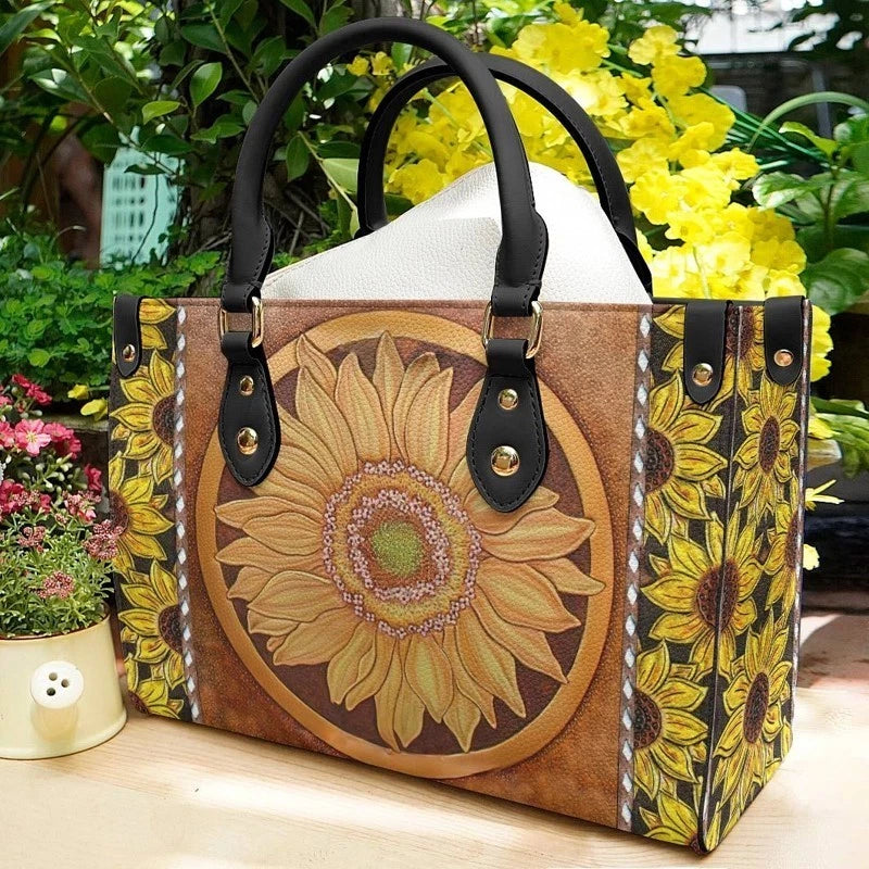 Sunflower floral leather-look handbag with top handles and zipper front, dark and tan