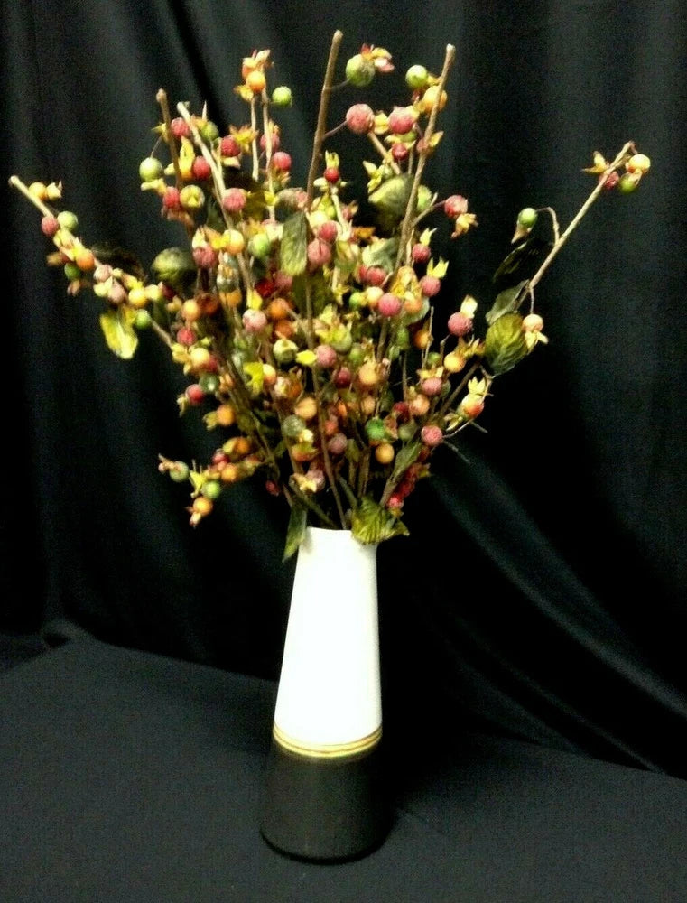 Artificial berry and flower pick stems with green, red, orange accents in a vase