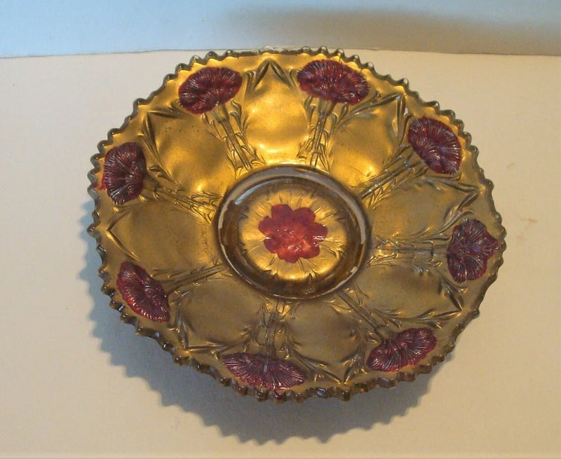 Antique goofus glass bowl in gold with red carnation center and scalloped sawtooth rim
