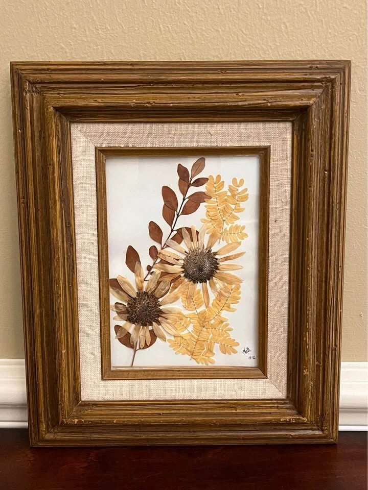 Vintage framed pressed flowers art with dried botanicals in beige and brown tones