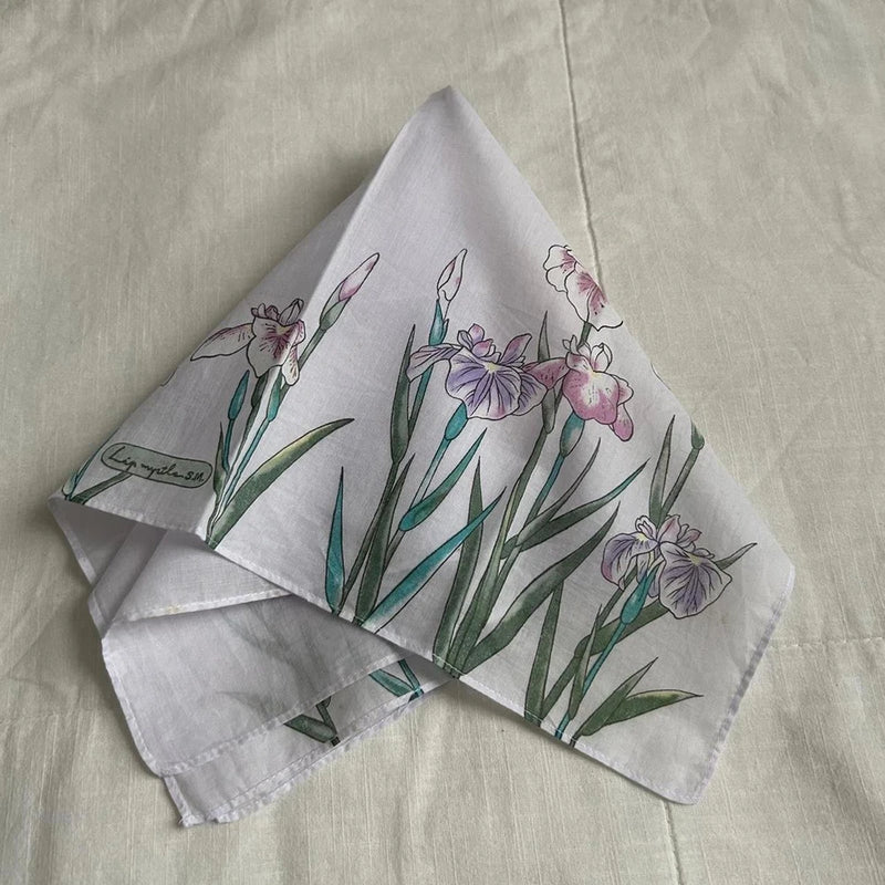 Floral lily-print bandana with pale lavender blossoms on a light gray base