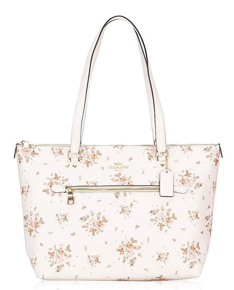 Coach large tote bag with off-white rose bouquet floral print, top handles, front zip pocket.