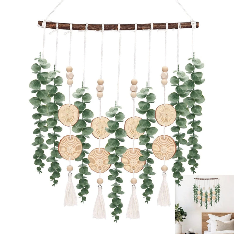 Artificial eucalyptus wall hanging with faux green leaves, wooden round discs, and white tassels
