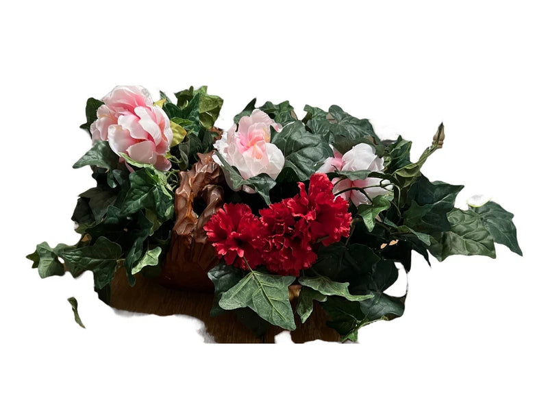 Wood basket flower arrangement with pink and red peonies and green ivy leaves