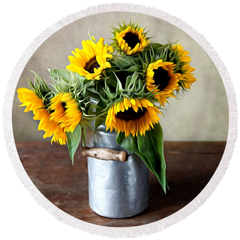 Silver pot vase filled with bright yellow sunflower flowers and green leaves
