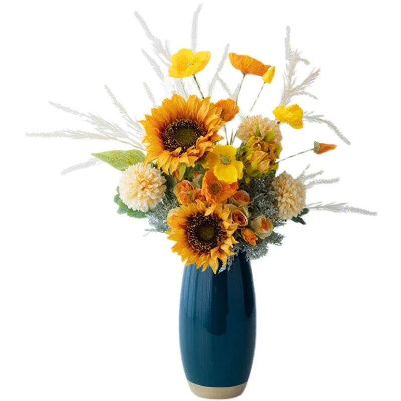 Artificial sunflower bouquet with mixed faux blooms in a blue vase