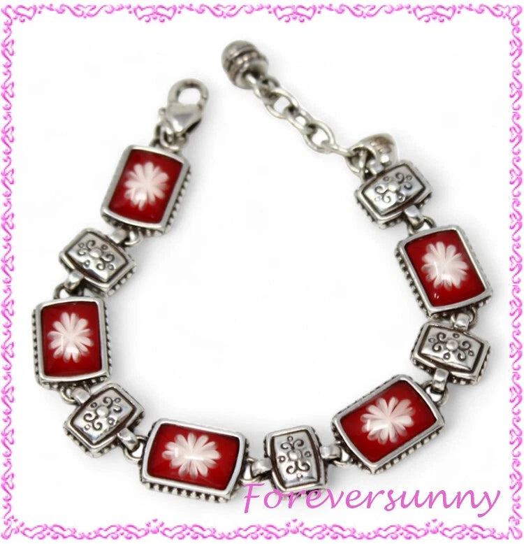 Silver-tone charm bracelet with red square enamel links and white flower motifs