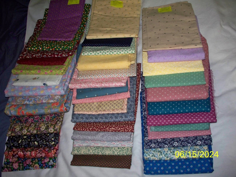 Assorted cotton quilting fabric bundle with small floral prints, folded in stacks