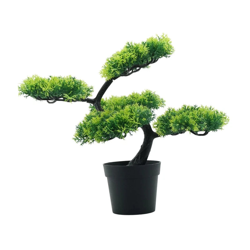 Artificial bonsai tree with green foliage in a black pot