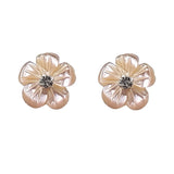 Silver flower stud earrings with gold-tone petals and a rhinestone center