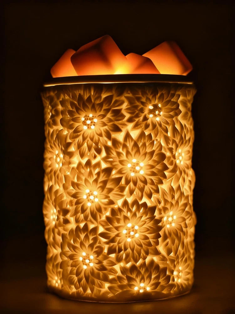 Ceramic wax melt warmer with floral relief, glowing warm light from top