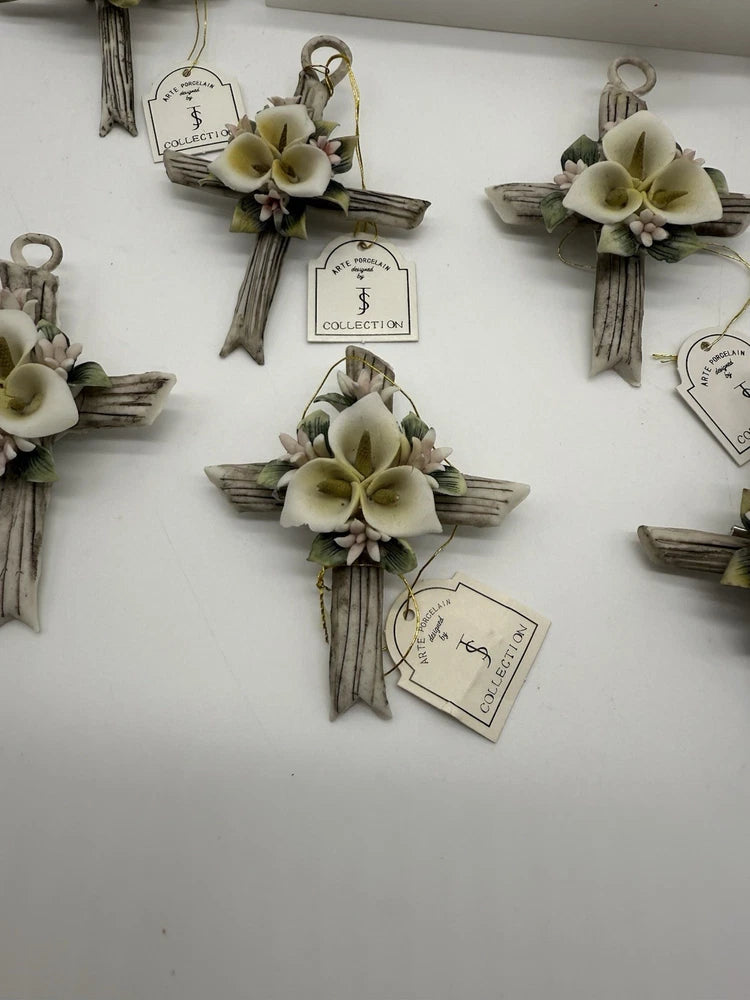 Porcelain cross brooch favors with ivory lily flowers and hanging ribbon tags