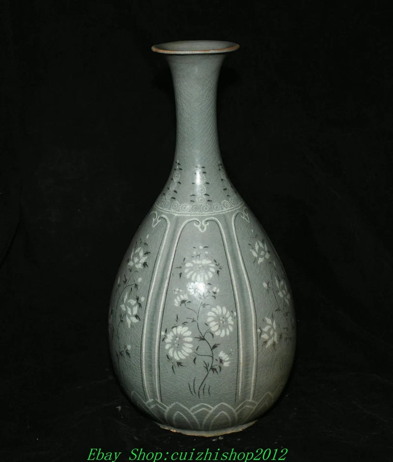 Light blue porcelain vase with narrow neck and embossed floral motifs, bottle shape