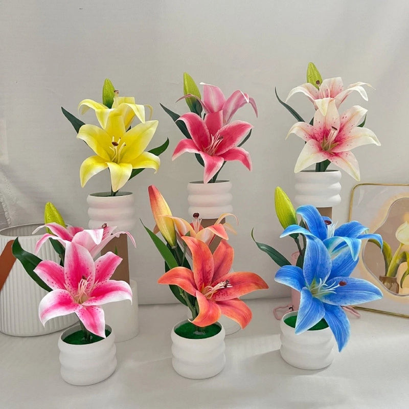 Set of artificial lily flowers in white pots, multicolor petals and green stems