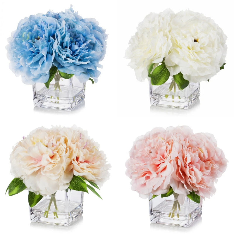 Four artificial peony centerpieces in cube glass vases, blue, white, cream, and peach.