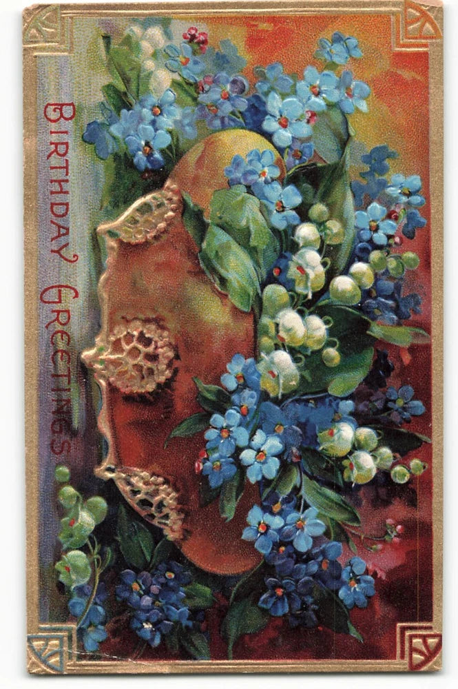 Vintage birthday greeting postcard with blue forget-me-nots, white lilies, and floral portrait