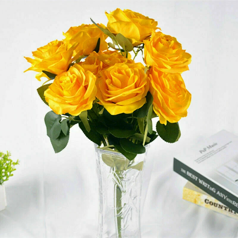 Artificial yellow rose bouquet in clear glass vase