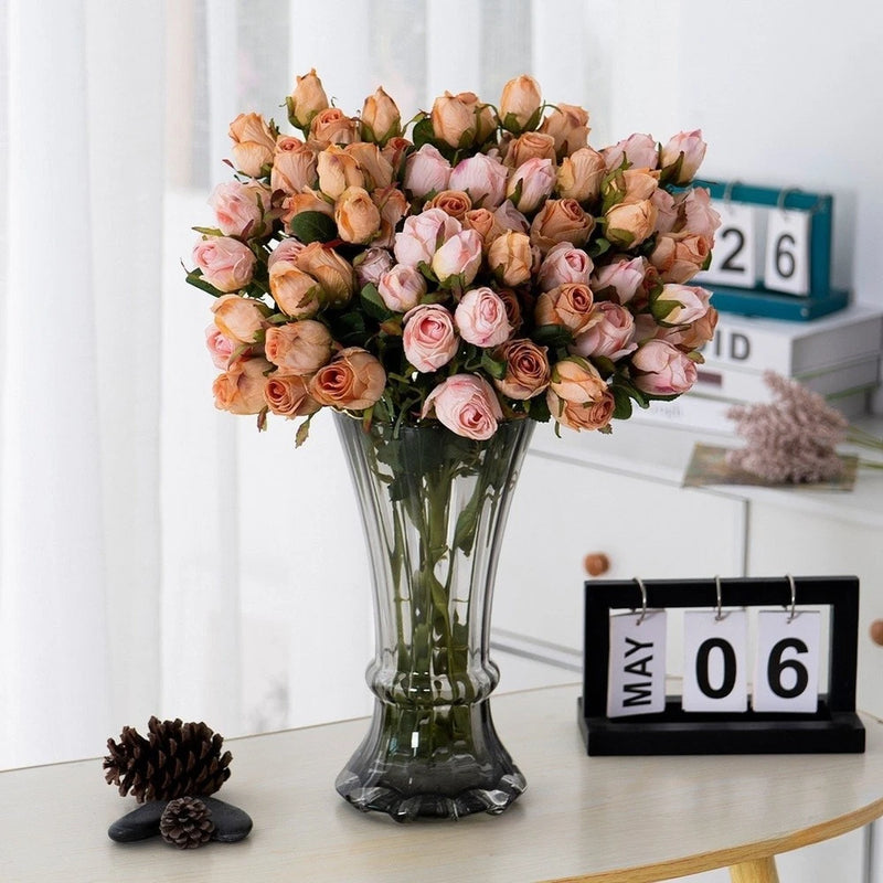 Silk faux rose bouquet with peach and pink blooms in clear glass vase