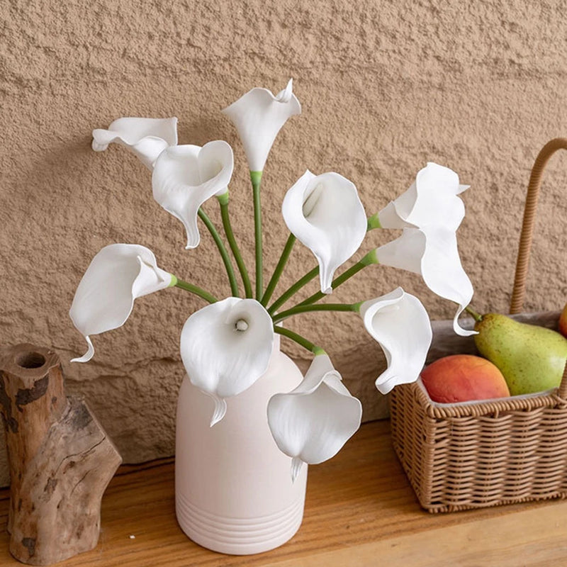 Artificial white calla lily flower bouquet in white ceramic vase