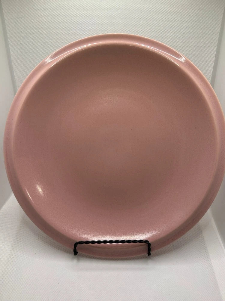 Large pink ceramic plate with glossy finish, shown from the front