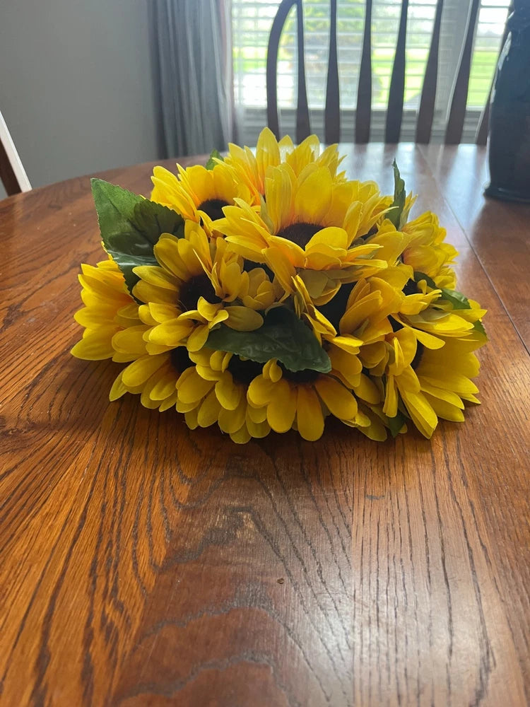Sunflower centerpiece floral arrangement with clustered yellow blooms and green leaves