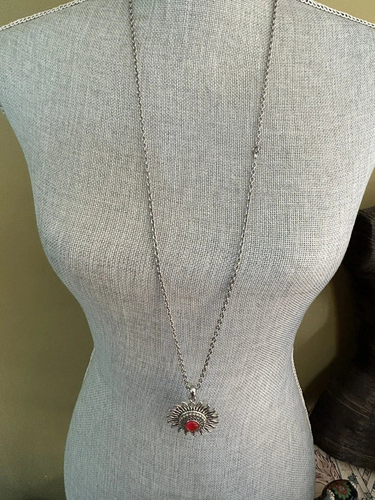 Silver-tone filigree flower pendant necklace with red cabochon