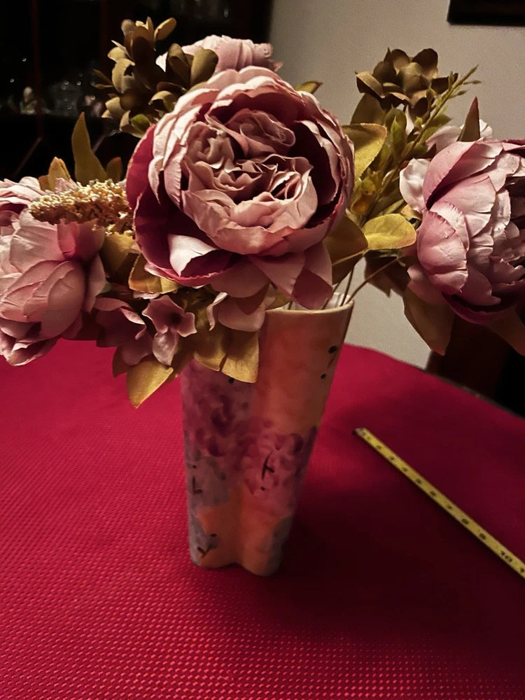 Silk peony floral centerpiece in pink and white blooms with green leaves, in patterned vase