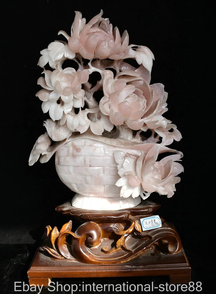 Carved pink and white flower basket statue with ornate brown base
