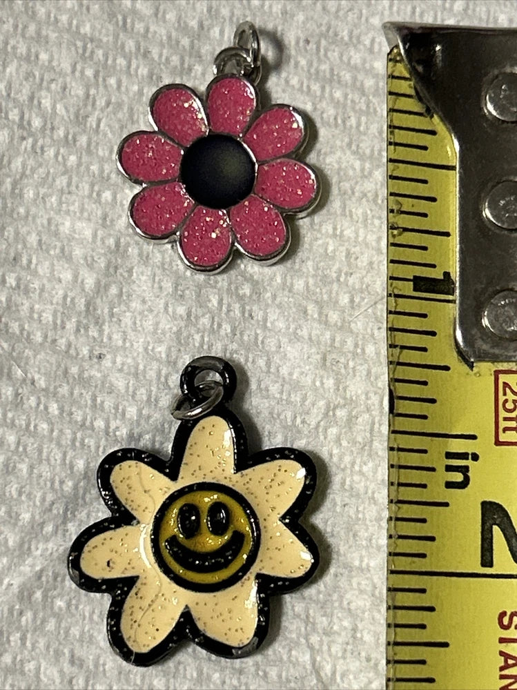 Flower necklace pendant pair: pink smiley flower and yellow smiley flower, black outlined