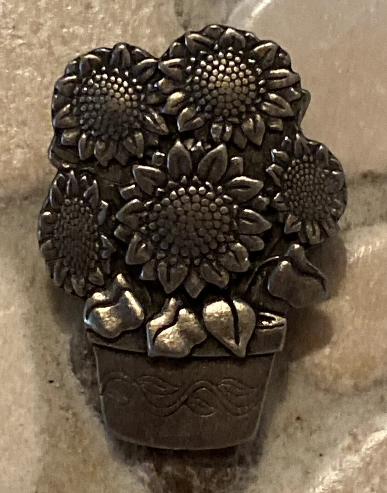 Dark metallic sunflower bouquet lapel pin with five flower heads and leaves