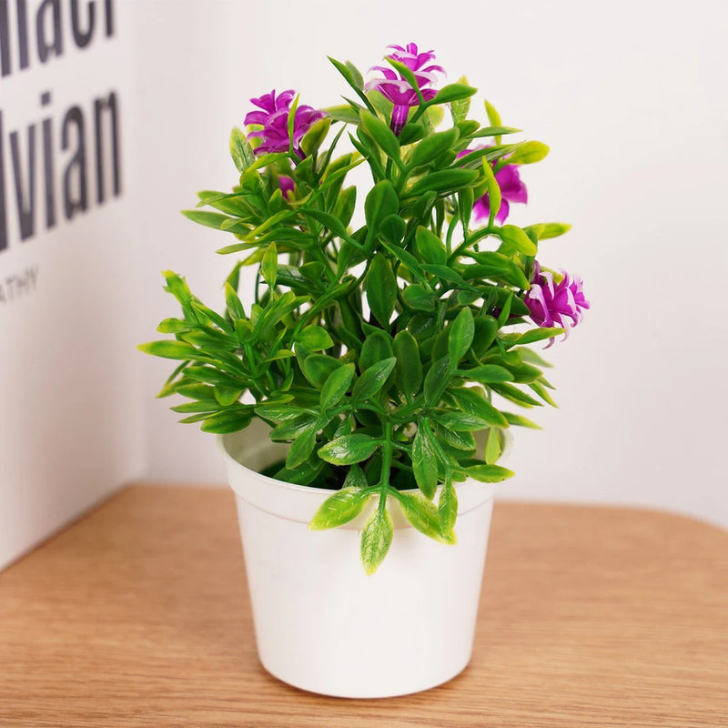 Small artificial bonsai plant with purple flowers in a white round pot