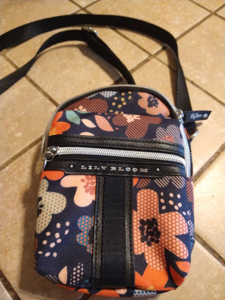 Small navy floral crossbody purse with dual zipper compartments and adjustable strap
