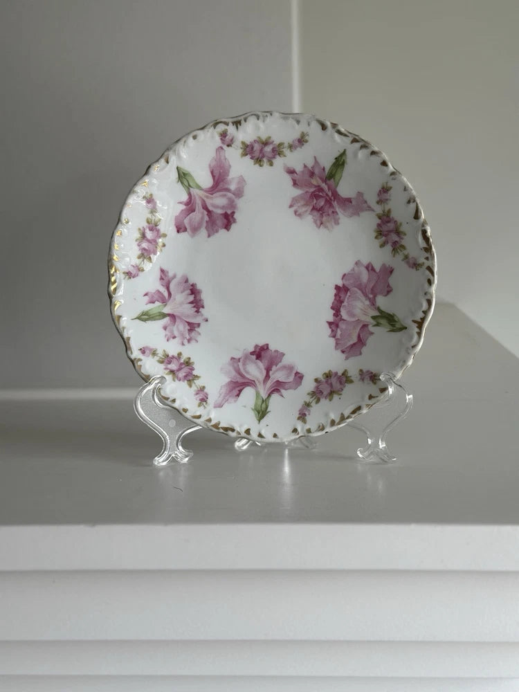 Antique porcelain dessert plate with pink and purple floral carnation pattern