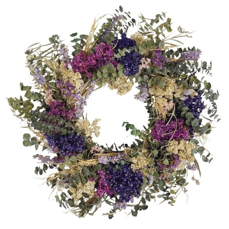 Dried flower wreath with magenta, purple and blue blooms and green foliage