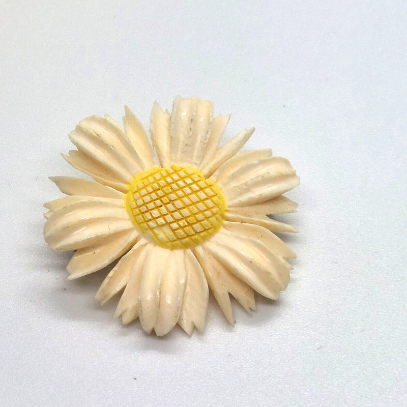 Plastic sunflower lapel pin with cream petals and yellow mesh center