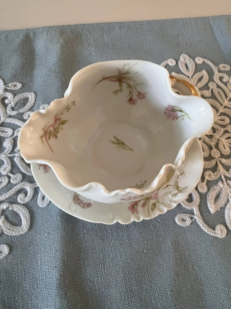 Scalloped porcelain gravy dish with pink carnation floral design and gilded rim