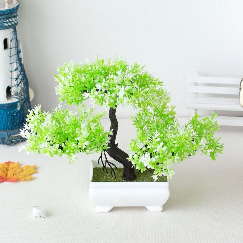 Artificial potted bonsai tree with bright green and white faux leaves in white planter