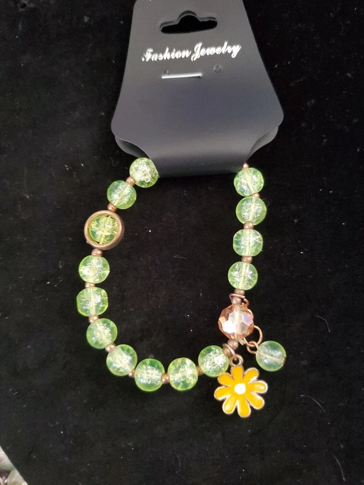 Sunflower charm stretch bracelet with green beads and yellow flower charm