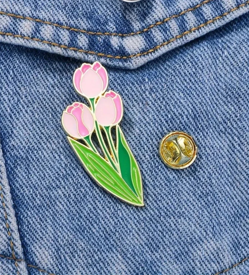 Enamel pink tulip flower pin badge with green leaves and gold outline
