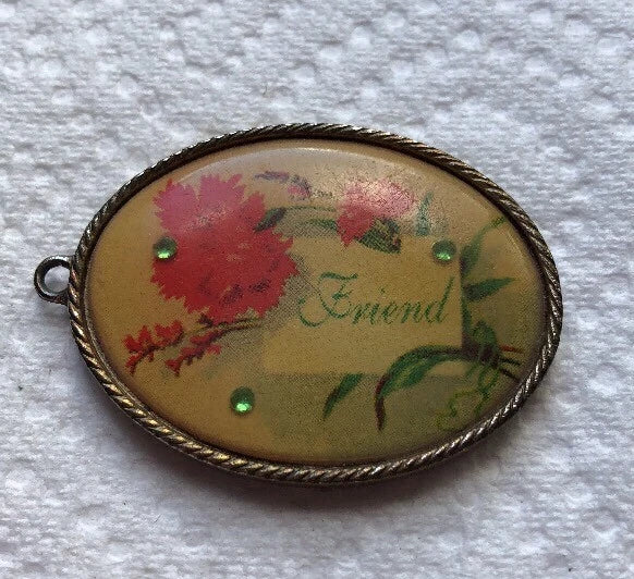 Oval floral pendant charm with red carnations, green leaves, and small stud accents