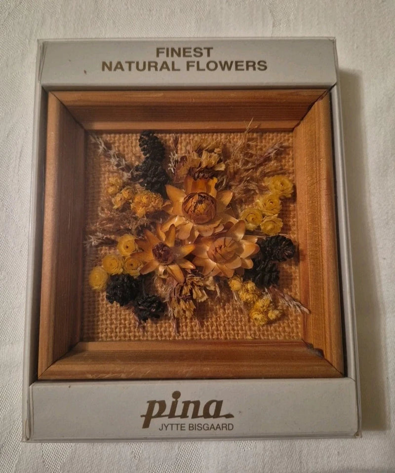 Framed dried flower wall art with wood frame and golden, dark dried blooms