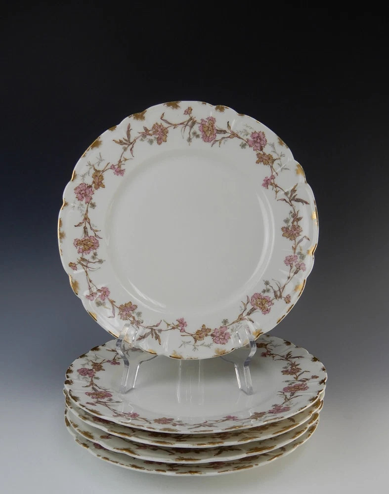 Set of five dinner plates, white porcelain with pink floral border and gold trim