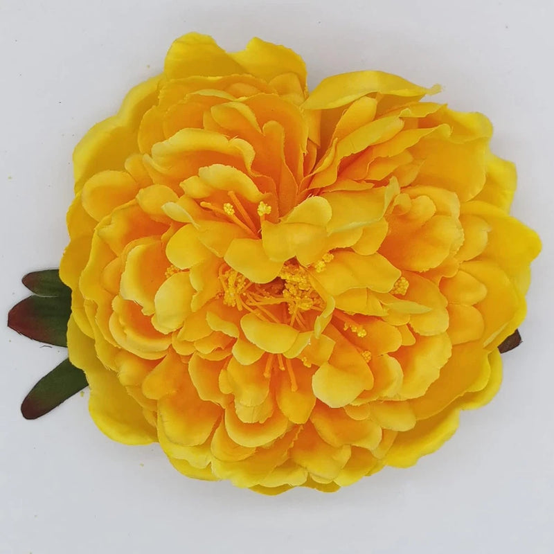 Yellow peony flower hair clip with layered petals and dark green leaf accents