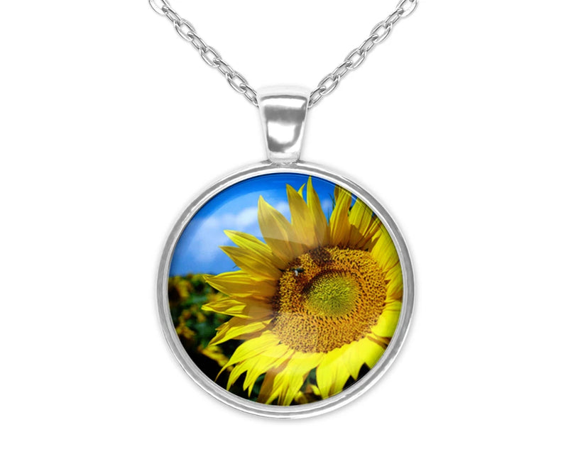 Sunflower charm pendant necklace with circular silver bezel and yellow flower photo